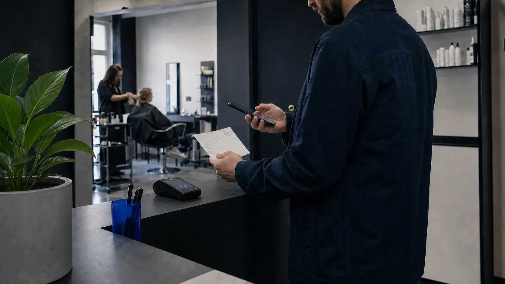 A small salon owner checking a customer booking between appointments